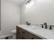 A newly renovated bathroom with double sink, gray cabinets and granite counters at 8215 S Nc 119 Hwy, Mebane, NC 27302