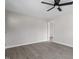 A spacious room with neutral walls and gray wood-look floors and ceiling fan at 8215 S Nc 119 Hwy, Mebane, NC 27302
