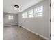 This bedroom has lots of natural light from multiple windows and wood-look floors at 8215 S Nc 119 Hwy, Mebane, NC 27302