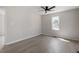 This bedroom features neutral walls, a window and gray wood-look floors at 8215 S Nc 119 Hwy, Mebane, NC 27302