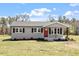Charming single-story home featuring a red front door and neatly landscaped yard at 8215 S Nc 119 Hwy, Mebane, NC 27302