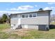 Back exterior of home with stairs leading to door and grassy lawn at 8215 S Nc 119 Hwy, Mebane, NC 27302