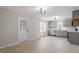Open concept kitchen with gray cabinets, stainless steel appliances, and a door to the yard at 8215 S Nc 119 Hwy, Mebane, NC 27302