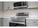 Close up of modern stainless steel appliances and quartz countertops in the kitchen at 8215 S Nc 119 Hwy, Mebane, NC 27302