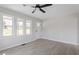 Bright living room with luxury vinyl plank flooring and ample natural light from the door and windows at 8215 S Nc 119 Hwy, Mebane, NC 27302