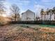 View of a large backyard featuring a wooden fence, trees, and ample space at 101 Adams Peak Ln, Garner, NC 27529