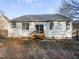 Back view of a home with a wooden deck, multiple windows, and a well-maintained backyard at 101 Adams Peak Ln, Garner, NC 27529
