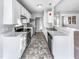 Modern kitchen featuring stainless steel appliances, white cabinetry, and a breakfast bar at 101 Adams Peak Ln, Garner, NC 27529