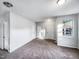 Spacious living room with a window, featuring neutral carpet and multiple entry points at 101 Adams Peak Ln, Garner, NC 27529