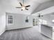 Open living area with vaulted ceiling, ceiling fans, slider, and abundant natural light at 101 Adams Peak Ln, Garner, NC 27529