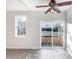 Bright living room with a ceiling fan, leading to a backyard through a sliding glass door at 101 Adams Peak Ln, Garner, NC 27529