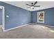 Bedroom with plush carpet, ceiling fan, and large windows at 1017 E Club Blvd, Durham, NC 27704