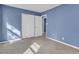 A spacious bedroom features plush carpeting and a closet, offering ample storage space at 1017 E Club Blvd, Durham, NC 27704