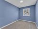 Bedroom features plush carpeting, blue walls and natural light at 1017 E Club Blvd, Durham, NC 27704