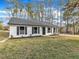 Charming single-story home with white brick, black shutters, and a well-manicured front lawn at 1017 E Club Blvd, Durham, NC 27704