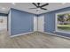 Bright living room boasts gray vinyl flooring, ceiling fan, and fresh blue walls at 1017 E Club Blvd, Durham, NC 27704