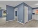 View of the open floor plan leading into the kitchen, which features gray vinyl floors, blue walls and white trim at 1017 E Club Blvd, Durham, NC 27704