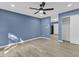 Bright living room boasts gray vinyl flooring, ceiling fan, and fresh blue walls at 1017 E Club Blvd, Durham, NC 27704