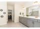Beautiful bathroom featuring double vanity, large mirror, walk-in closet, and tiled shower at 1040 Lippincott Rd, Durham, NC 27703