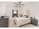 Cozy bedroom with neutral decor, ceiling fan and a large window for natural light at 1040 Lippincott Rd, Durham, NC 27703