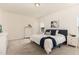 Well-lit bedroom with large windows, neutral tones, and cozy decor at 1040 Lippincott Rd, Durham, NC 27703