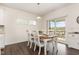 Bright dining area with wood table, white chairs and sliding glass door to the outdoors at 1040 Lippincott Rd, Durham, NC 27703