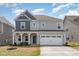 Charming two-story home with a welcoming front porch and a two-car garage at 1040 Lippincott Rd, Durham, NC 27703
