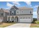 Charming two-story home with a welcoming front porch and a two-car garage at 1040 Lippincott Rd, Durham, NC 27703