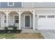 Inviting front entrance with a cozy porch and a charming wreath on the door at 1040 Lippincott Rd, Durham, NC 27703