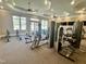 Well-equipped gym with modern exercise machines, fans, and ample natural light at 1040 Lippincott Rd, Durham, NC 27703