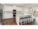 Modern kitchen with stainless steel appliances, a kitchen island with stool seating, and white cabinets at 1040 Lippincott Rd, Durham, NC 27703