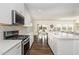 Open kitchen with an island, stainless steel appliances, and direct view to the dining and living rooms at 1040 Lippincott Rd, Durham, NC 27703