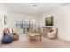 Cozy living room with plush seating, natural light, and comfortable carpeting at 1040 Lippincott Rd, Durham, NC 27703