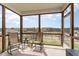 Relaxing screened porch with comfortable seating and a beautiful view of the outdoors at 1040 Lippincott Rd, Durham, NC 27703