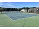 Well-maintained community tennis court with basketball hoops for friendly games and recreation at 1040 Lippincott Rd, Durham, NC 27703