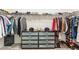 Organized walk-in closet with shelving, hanging rods, and built-in drawers for storage at 1040 Lippincott Rd, Durham, NC 27703