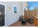 Outdoor deck offers space for seating with wood railings and gray siding at 106 Madison Square Ln, Cary, NC 27513