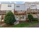 Backyard view of multiple decks with wood supports and green landscaping at 106 Madison Square Ln, Cary, NC 27513