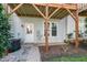 Exterior backyard features an outdoor deck with wooden pillars and stone pavers at 106 Madison Square Ln, Cary, NC 27513