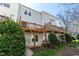 Backyard view of multiple decks with wood supports and green landscaping at 106 Madison Square Ln, Cary, NC 27513