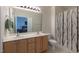 Bathroom with a double sink vanity and a shower/tub with patterned curtain at 106 Madison Square Ln, Cary, NC 27513