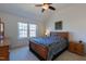 Vaulted ceiling bedroom with large window, wood furniture, and ceiling fan at 106 Madison Square Ln, Cary, NC 27513