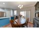 Bright dining room features wood table, chandelier, and sliding doors to the backyard at 106 Madison Square Ln, Cary, NC 27513