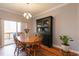 Dining area showcasing a wooden table, hutch, and sliding glass door to backyard at 106 Madison Square Ln, Cary, NC 27513