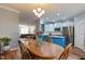 Open dining area with views into the kitchen and living room with hardwood floors at 106 Madison Square Ln, Cary, NC 27513