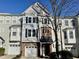 Inviting townhome showcases a charming facade with a private garage and a well-maintained lawn at 106 Madison Square Ln, Cary, NC 27513