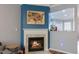 Cozy fireplace with white mantel, tile surround, and views into kitchen at 106 Madison Square Ln, Cary, NC 27513