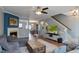 Spacious living room with hardwood floors, a large gray sectional, and a view into the dining room at 106 Madison Square Ln, Cary, NC 27513