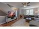 Cozy living area with a TV, hardwood floors, and a comfortable sofa, ideal for relaxing and entertaining at 106 Madison Square Ln, Cary, NC 27513