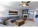 Open-concept living room with a plush gray sofa, a fireplace, and an adjacent dining area at 106 Madison Square Ln, Cary, NC 27513